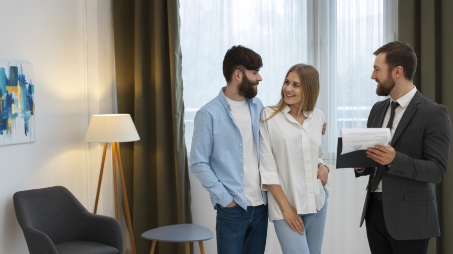 male-real-estate-agent-doing-business-showing-house-potential-buying-couple